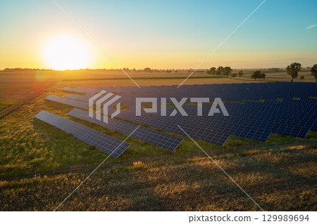 Solar panels at sunset 129989694