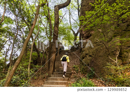 Hiker hiking the serene Boshi hill near West Lake in Hangzhou Hiker hiking the serene Boshi hill near West Lake in Hangzhou 129989852