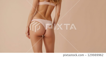 Elegant woman in minimal lingerie posing against soft pastel background Elegant woman in minimal lingerie posing against soft pastel background 129989962