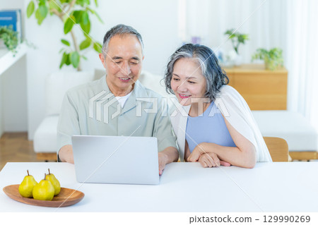 Senior couple seeing computer Senior couple seeing computer 129990269