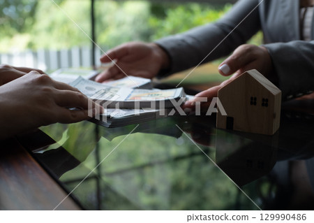 Real estate agent presenting and approved home loan contract. Real estate investment, Home mortgage concept. Real estate agent presenting and approved home loan contract. Real estate investment, Home mortgage concept. 129990486