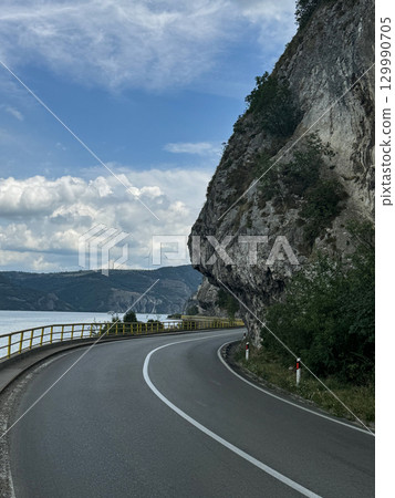 View of the highway and cliffs. The Golubac Castle was a medieval fortified town on the Danube River in Serbia View of the highway and cliffs. The Golubac Castle was a medieval fortified town on the Danube River in Serbia 129990705