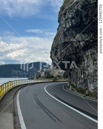View of the highway and cliffs. The Golubac Castle was a medieval fortified town on the Danube River in Serbia View of the highway and cliffs. The Golubac Castle was a medieval fortified town on the Danube River in Serbia 129990706