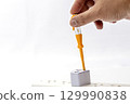 Hand using tester screwdriver on power strip socket electrical safety check white background close up precaution home maintenance risk awareness careful action indoor adult hand 129990838