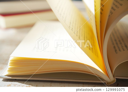 Autumn is the season for reading. Open a book (image) 129991075