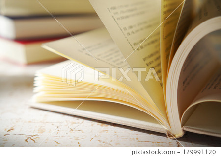 Autumn is the season for reading. Open a book (image) Autumn is the season for reading. Open a book (image) 129991120