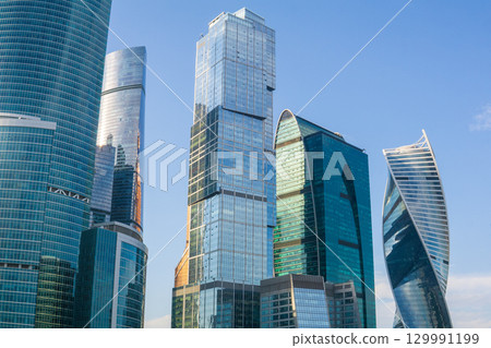 urban background, view of modern skyscrapers against blue sky urban background, view of modern skyscrapers against blue sky 129991199