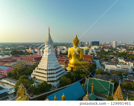 aerial view scenery sky of sunset at golden big Buddha popular landmark in Bangkok. aerial view scenery sky of sunset at golden big Buddha popular landmark in Bangkok. 129991461