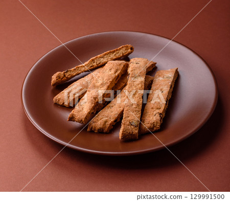 Biscotti or cantuccini biscuits, a crispy sweet Italian pastry. Biscotti dessert Biscotti or cantuccini biscuits, a crispy sweet Italian pastry. Biscotti dessert 129991500