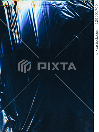 Crumpled foil. Glitch glow flare. Fiction color light scratch defocused black background copy space. Distressed gradient distortion surface. 129991769