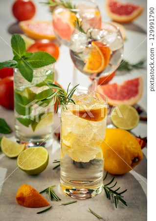 Refreshing summer cocktails with citrus on a white marble table. 129991790