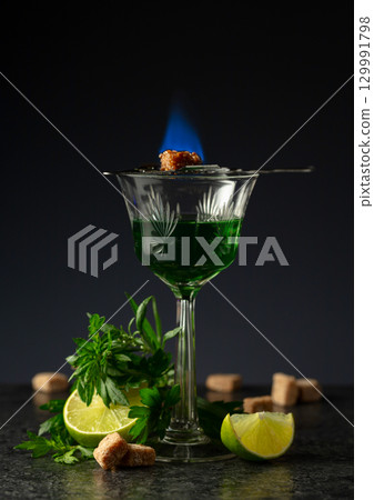 Burning sugar on a glass with absinthe. Burning sugar on a glass with absinthe. 129991798
