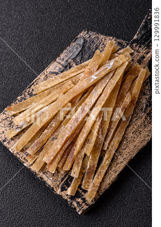 Food, snacks or jerky made from dried dehydrated salted fish with spices. Snacks fish Food, snacks or jerky made from dried dehydrated salted fish with spices. Snacks fish 129991836