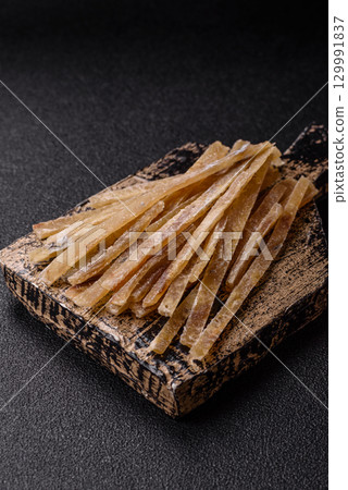 Food, snacks or jerky made from dried dehydrated salted fish with spices. Snacks fish 129991837