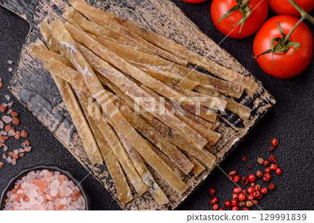 Food, snacks or jerky made from dried dehydrated salted fish with spices. Snacks fish 129991839