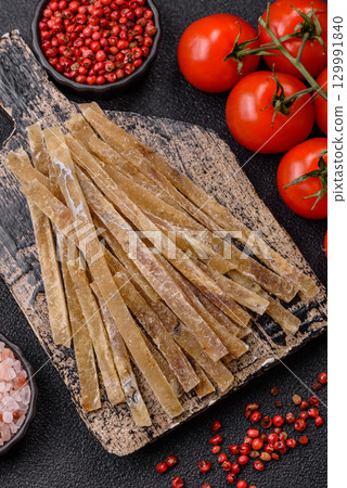 Food, snacks or jerky made from dried dehydrated salted fish with spices. Snacks fish 129991840
