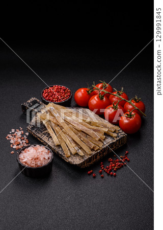 Food, snacks or jerky made from dried dehydrated salted fish with spices. Snacks fish Food, snacks or jerky made from dried dehydrated salted fish with spices. Snacks fish 129991845