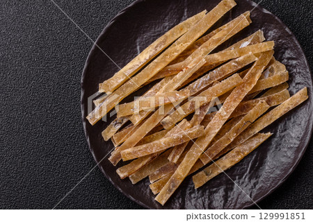 Food, snacks or jerky made from dried dehydrated salted fish with spices. Snacks fish Food, snacks or jerky made from dried dehydrated salted fish with spices. Snacks fish 129991851
