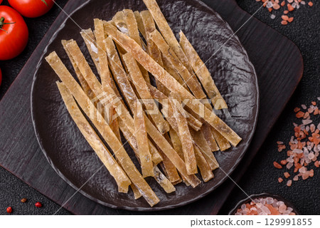 Food, snacks or jerky made from dried dehydrated salted fish with spices. Snacks fish Food, snacks or jerky made from dried dehydrated salted fish with spices. Snacks fish 129991855