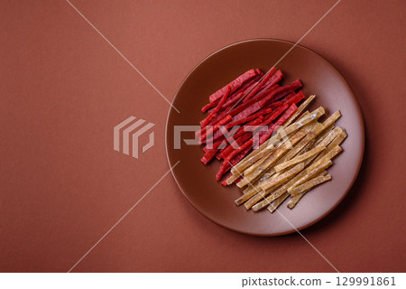 A set of jerky or snacks of chicken and fish with salt and spices A set of jerky or snacks of chicken and fish with salt and spices 129991861