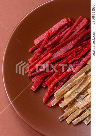 A set of jerky or snacks of chicken and fish with salt and spices A set of jerky or snacks of chicken and fish with salt and spices 129991866