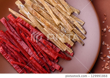 A set of jerky or snacks of chicken and fish with salt and spices A set of jerky or snacks of chicken and fish with salt and spices 129991868