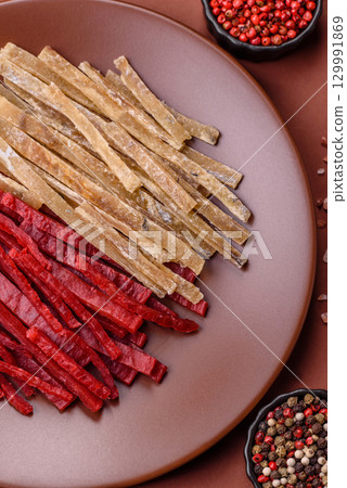 A set of jerky or snacks of chicken and fish with salt and spices A set of jerky or snacks of chicken and fish with salt and spices 129991869