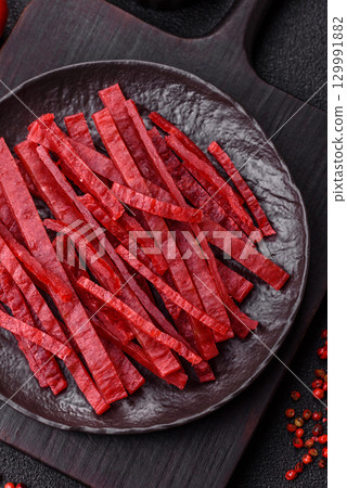 Jerky or dried chicken and cherry snacks. Dehydrated, dried snacks for beer 129991882