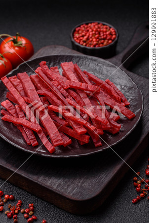 Jerky or dried chicken and cherry snacks. Dehydrated, dried snacks for beer 129991883