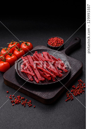 Jerky or dried chicken and cherry snacks. Dehydrated, dried snacks for beer 129991887