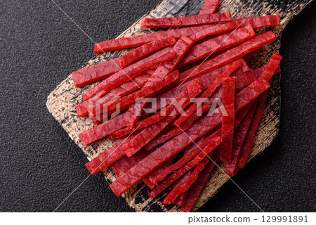 Jerky or dried chicken and cherry snacks. Dehydrated, dried snacks for beer 129991891