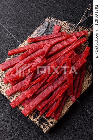 Jerky or dried chicken and cherry snacks. Dehydrated, dried snacks for beer 129991892