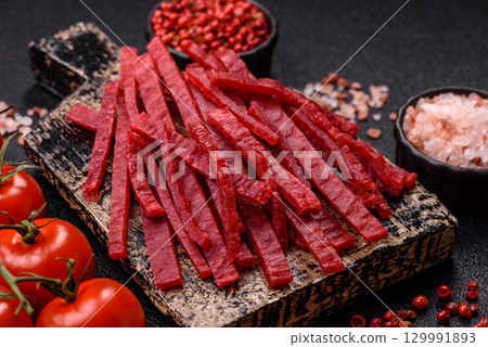 Jerky or dried chicken and cherry snacks. Dehydrated, dried snacks for beer 129991893