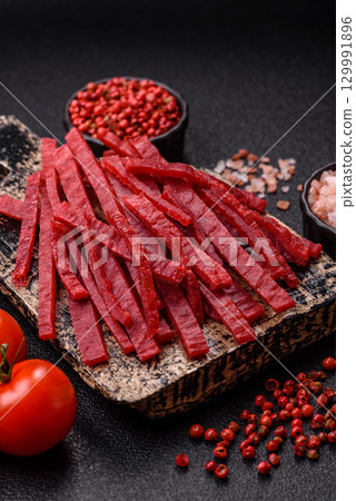 Jerky or dried chicken and cherry snacks. Dehydrated, dried snacks for beer Jerky or dried chicken and cherry snacks. Dehydrated, dried snacks for beer 129991896