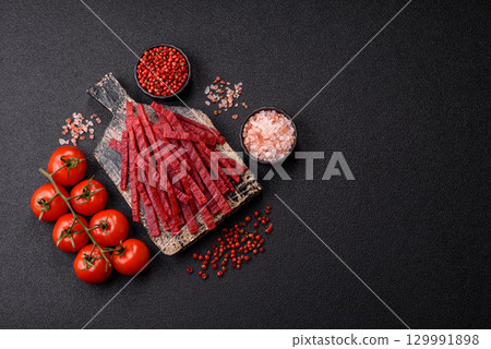 Jerky or dried chicken and cherry snacks. Dehydrated, dried snacks for beer 129991898