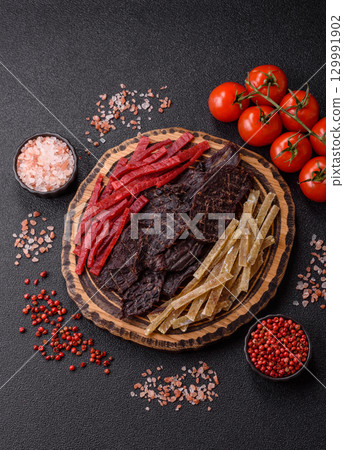 A set of jerky or snacks of beef, chicken and fish with salt and spices A set of jerky or snacks of beef, chicken and fish with salt and spices 129991902