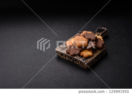 Sweet crispy biscuit with cocoa flavor, baking at home. Biscuit as a dessert 129991950