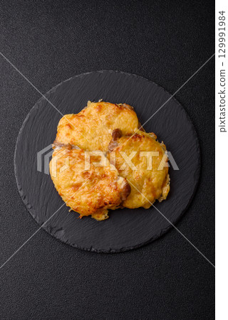 Steak, a pork or chicken chop covered with melted cheese. Grilled meat 129991984