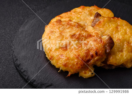 Steak, a pork or chicken chop covered with melted cheese. Grilled meat Steak, a pork or chicken chop covered with melted cheese. Grilled meat 129991986