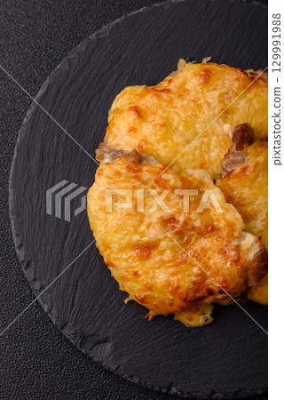 Steak, a pork or chicken chop covered with melted cheese. Grilled meat 129991988