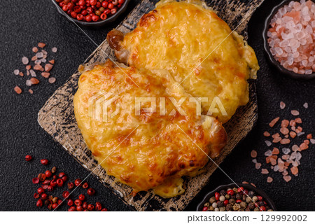 Steak, a pork or chicken chop covered with melted cheese. Grilled meat 129992002