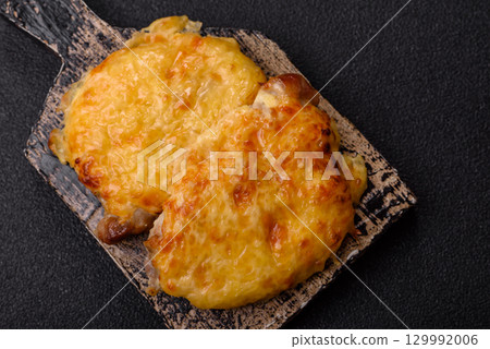 Steak, a pork or chicken chop covered with melted cheese. Grilled meat Steak, a pork or chicken chop covered with melted cheese. Grilled meat 129992006