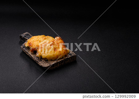 Steak, a pork or chicken chop covered with melted cheese. Grilled meat Steak, a pork or chicken chop covered with melted cheese. Grilled meat 129992009