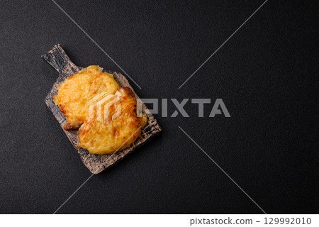 Steak, a pork or chicken chop covered with melted cheese. Grilled meat Steak, a pork or chicken chop covered with melted cheese. Grilled meat 129992010