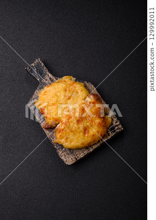 Steak, a pork or chicken chop covered with melted cheese. Grilled meat Steak, a pork or chicken chop covered with melted cheese. Grilled meat 129992011