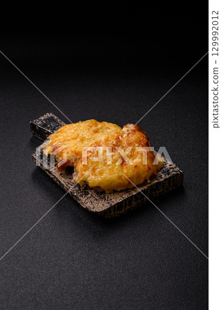 Steak, a pork or chicken chop covered with melted cheese. Grilled meat Steak, a pork or chicken chop covered with melted cheese. Grilled meat 129992012