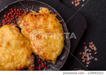 Steak, a pork or chicken chop covered with melted cheese. Grilled meat 129992022