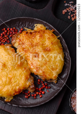 Steak, a pork or chicken chop covered with melted cheese. Grilled meat 129992023