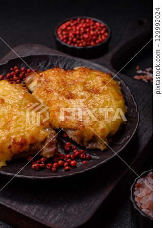 Steak, a pork or chicken chop covered with melted cheese. Grilled meat 129992024