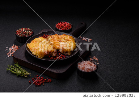Steak, a pork or chicken chop covered with melted cheese. Grilled meat Steak, a pork or chicken chop covered with melted cheese. Grilled meat 129992025
